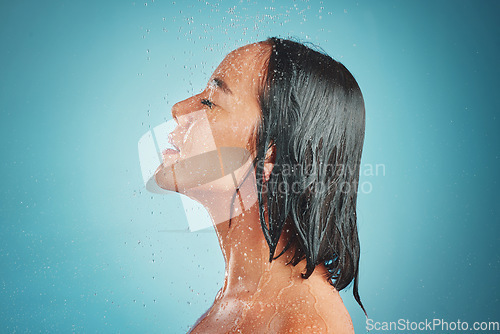 Image of Woman, hygiene and wet shower for relax, beauty or fresh clean with water drops against a blue studio background. Relaxed female enjoying a hygienic wash and liquid sensation in cleanliness on mockup