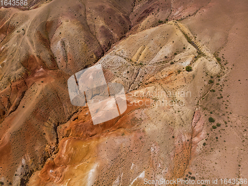 Image of Aerial shot of the textured yellow nad red mountains resembling the surface of Mars