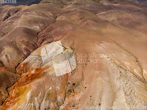 Image of Aerial shot of the textured yellow nad red mountains resembling the surface of Mars