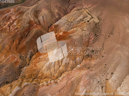 Image of Aerial shot of the textured yellow nad red mountains resembling the surface of Mars