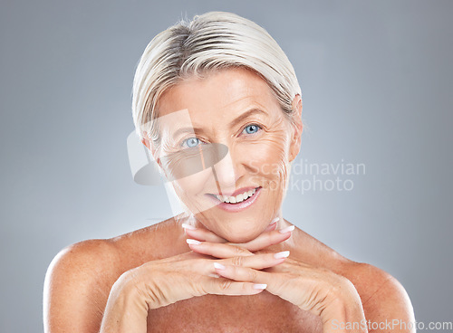 Image of Face, beauty and skincare with a mature woman in studio on a gray background for antiaging treatment. Wellness, portrait and cosmetics with a senior female posing to promote a natural skin product
