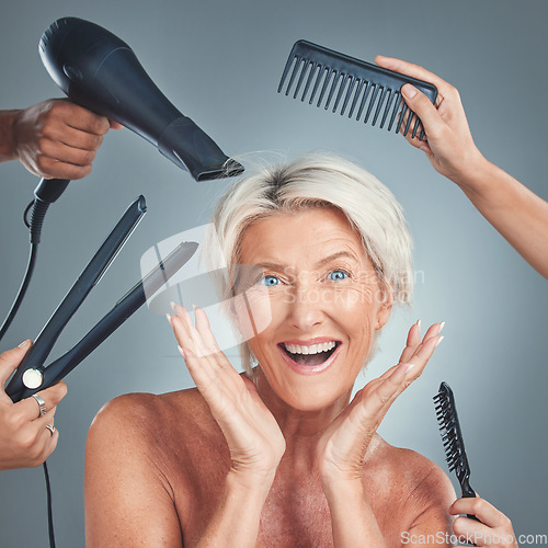 Image of Hair care, excited and senior woman with hairdresser for beauty, haircut and preparation on grey studio background. Happy, smile and surprise face of an elderly model with hands of stylist for hair