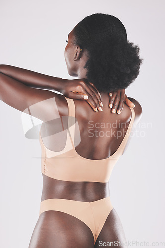 Image of Beauty, back and lingerie by black woman in studio for skincare, grooming and hygiene on a grey background. Wellness, girl and nigerian model relax with pamper, massage and skin treatment with mockup