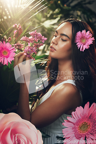 Image of Flowers, gardening and woman in a forest, nature or park for peace, zen or wellness. Spring, plants and model in a garden with an aster flower and floral natural environment with trees in summer