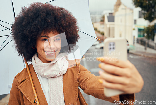 Image of Selfie, smile and woman with a phone and umbrella during winter in the street of Australia. Video call, 5g communication and girl with a mobile photo and live streaming in the street during rain