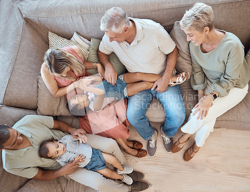 Image of Interracial family, fun and sofa in a home living room with a happy mom, grandparents and children. Top view of happiness, smile and kids bonding with elderly people, mother and dad on a house couch