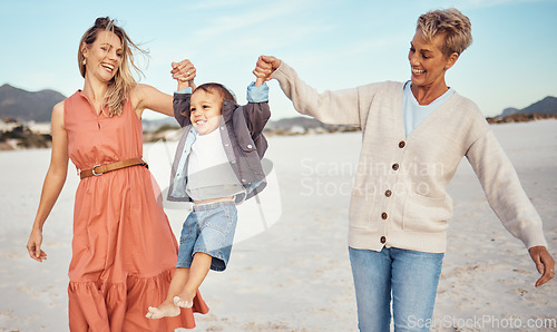 Image of Happy, mother and grandmother holding hands with child at the beach for fun family time together in the outdoors. Mama, grandma and kid swinging in the air for playful walk at the sandy ocean outside