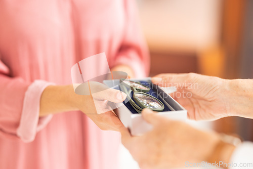 Image of Optometry, eyewear and woman with glasses in a box after shopping in a retail optical store. Closeup of an optometrist helping a patient with her new spectacles in a case at an optics shop or clinic.