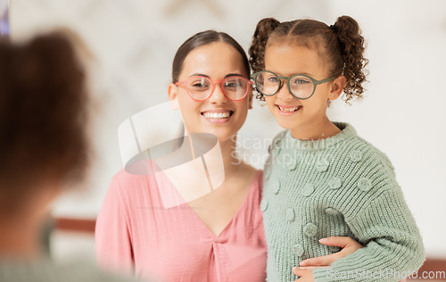 Image of Glasses, mirror and mother with child happy for vision eye care insurance, frame choice and medical family deal, promotion or discount. Happy mom and girl kid with eyes service in lens shop or store