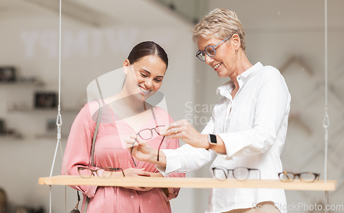 Image of Eye care, vision and woman is shopping for glasses with a trusted optician helping with advice at an optometrist. Smile, eyesight and happy customer buying frames for a discount sales deal at a store