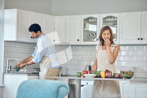 Image of Health cooking, eating and couple in a kitchen with vegetables and salad for vitamins and wellness. Diet, nutrition and food recipe of a wife and man together making a healthy dinner meal at home