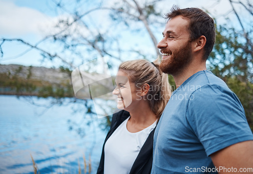 Image of Couple, smile and lake in nature for camping, bonding and morning view with happiness outdoor. Man, woman and happy by calm water together on vacation, adventure or holiday for rest, relax and peace