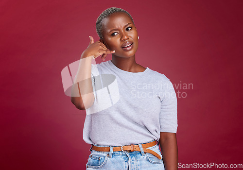 Image of Black woman, annoyed and hand phone call sign by studio background for question, communication or network. Model, woman and call me symbol with frown while frustrated, thinking or confused in tech