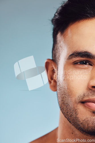 Image of skincare, beauty and face of man in studio portrait on blue mock up for healthcare, wellness and skin glow marketing, advertising or promotion space. Young model cosmetics mockup for beard skin care