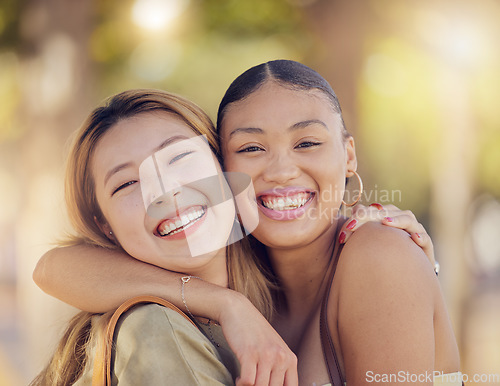 Image of Asian, women friends and happy portrait in outdoor sunshine with embrace, hug and smile in summer. Happy diversity, best friends and happy with happiness in metro together on vacation in Jakarta