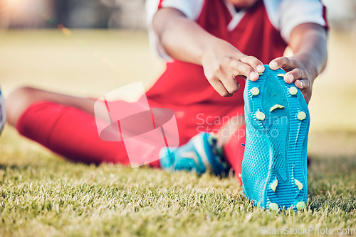 Image of Stretching, foot and soccer player on field for sports training, exercise and legs muscle wellness health zoom. Football athlete with shoes or sneakers gear for warmup workout or game on grass pitch