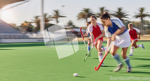 Image of Sports, hockey and women in action on field playing game, match and training in outdoor stadium. Fitness, exercise and blur of female athletes running with speed for victory, winning and score goal