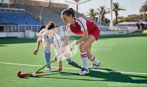 Image of Sports fitness, field hockey game and women challenge for ball in stadium competition, club rival match or tournament contest. Training exercise, workout and athlete battle action on arena turf pitch