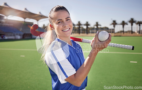 Image of Sports, hockey and woman at a stadium for fitness, training and game practice, happy and proud. Field hockey, coach and sport leader portrait of lady holding a ball before endurance match on a field