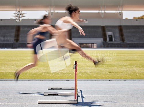 Image of Woman, sports and hurdle athletics running for exercise, training or workout at the stadium track outdoors. Fitness women athletes in competitive sport jumping over hurdles for healthy cardio outside