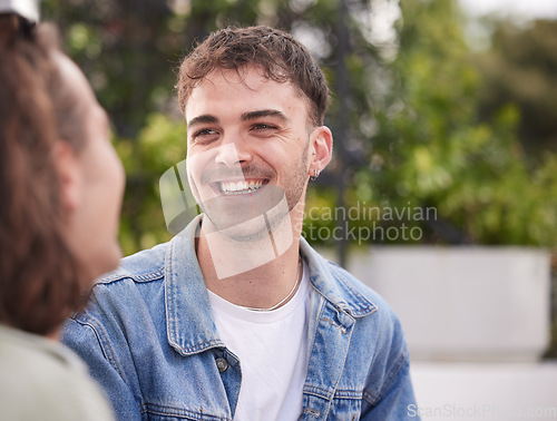 Image of Happy man, smile and face of gay, homosexual or lgbtq guy sitting outdoor on a date while having a conversation about happiness, lifestyle and love. Gen z male in nature while talking to partner