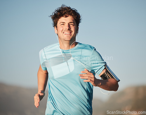 Image of Happy, running and man athlete with music steaming in nature for fitness and training in nature. Portrait of a happy, healthy and smile of a runner in the sun doing a cardio sports workout exercise