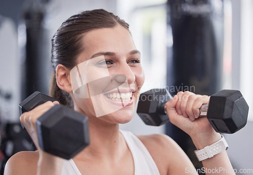 Image of Fitness, exercise and woman with dumbbell in the gym doing workout, training and weight lifting. Health, wellness and happy female exercising with equipment in sports center with smile on face