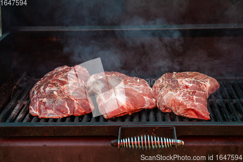 Image of Pork meat steaks on the grill