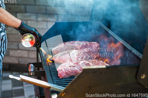 Image of Pork meat steaks on the grill