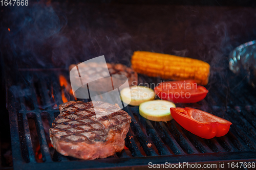 Image of Pork meat steaks on the grill