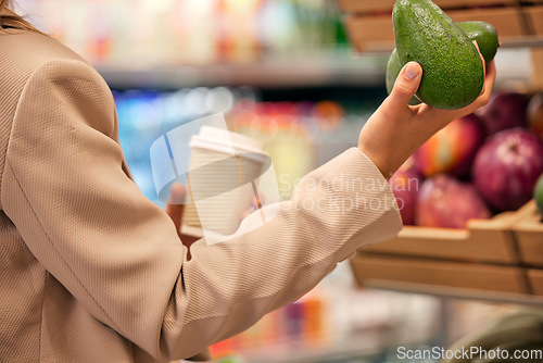 Image of Supermarket, avocado and woman hand shopping for fruit, fresh and produce at grocery store. Retail, food and customer buying organic product for health, diet and wellness, detox and healthy lifestyle