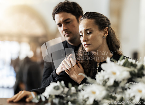 Image of Sad, funeral and flowers with couple and coffin in church for death, respect and mourning. Grief, goodbye and empathy with man and woman loss at casket with depression, remember and farewell memorial