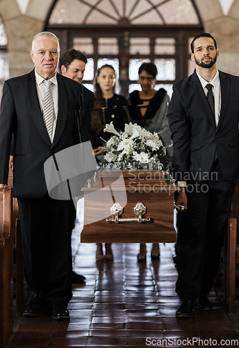 Image of Funeral, church and family carry coffin for death, grief or sermon for burial with support. People, pallbearers and sad together with casket for respect, farewell or sorrow in mourning, mass or loss