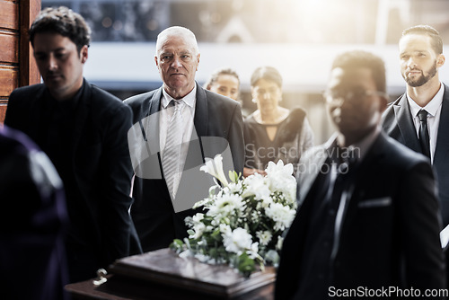 Image of Sad, funeral and people with coffin at church for service, mourning and grief over death. Flowers, depression and ceremony with family carrying casket in chapel for sorrow, support and loss together