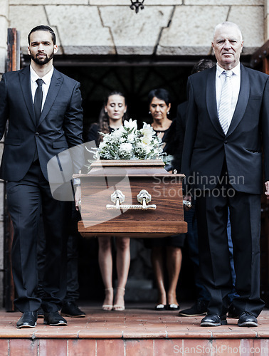 Image of Funeral, church and people with a coffin, family and mourning in emotional distress. Church service, casket and burial with sad men and women carrying dead person together out of a chapel door