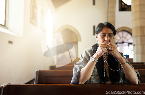 Image of Pray, church and senior woman praying with a rosary in a calm, zen chapel alone, holy and spiritual. Prayer, worship and mexican lady connect with God, Jesus and christian religion in Mexico