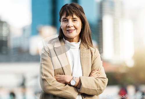 Image of Senior business woman, portrait and arms crossed in city with smile. Vision, leadership and success mindset of mature female ceo, manager or company leader happy with goals, targets or career growth