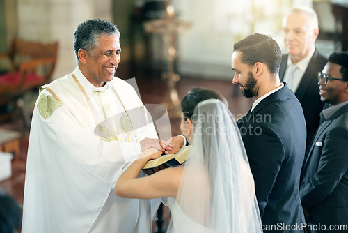 Image of Happy priest, wedding and couple in church for ceremony, service or celebration with bible, witness and God. Father, bride and man with spiritual book for love, vows and marriage in christian event