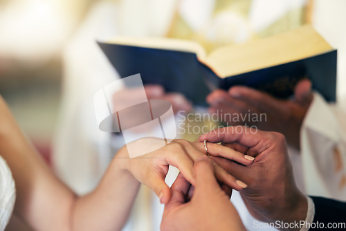 Image of Couple hands with ring, wedding and marriage in church with priest and bible in traditional ceremony. Commitment, love and jewelry, man and woman together with trust and jewellery with bride.