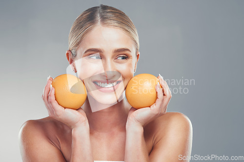 Image of Orange, skincare and woman thinking of cosmetics, beauty and health of body against a grey mockup studio background. Happy, healthy and young model with vitamin c fruit for wellness and diet