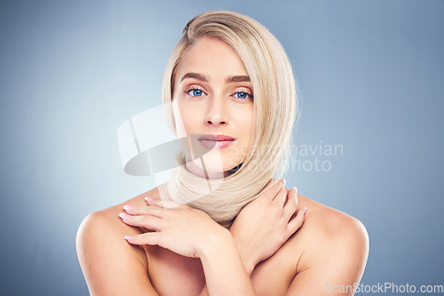 Image of Beauty, hair and blonde with portrait of woman for shampoo, salon and health. Wellness, skincare and makeup with girl model for cosmetics, keratin and shine against a blue background in studio