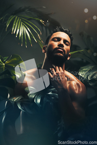 Image of Beauty, skincare and nature with a man model in studio on a natural rainforest or amazon background. Cosmetics, wellness and plants with a handsome young male posing indoors on a jungle setting