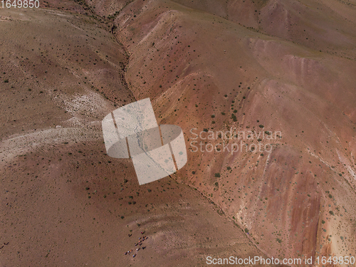 Image of Aerial shot of the textured yellow nad red mountains resembling the surface of Mars