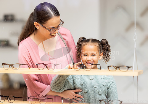 Image of Decision, glasses and girl with her mother at the optometrist for vision and check on eyes together. Customer, medical and child shopping for eyeglasses with her mom at the ophthalmologist clinic