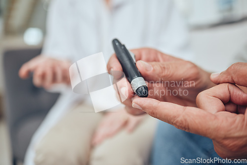 Image of Finger, healthcare and diabetes with a senior man testing his blood sugar level while in his retirement home. Medical, wellness and test with a mature male using a glucometer to measure his glucose