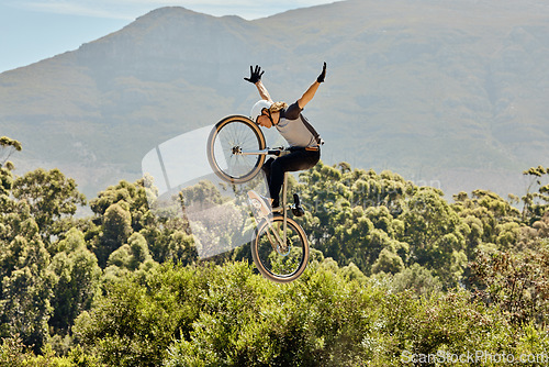 Image of Mountain bike, nature and sports man jump in air with outdoor adventure, journey and training in bush or forest mock up for marketing. Risk, danger and sport bicycle person in sky freedom and fitness