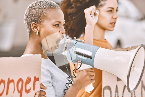 Image of Protest, angry and black woman with a megaphone as leadership for social change, justice and freedom from government. Conflict, fight and African girl shouting during a rally against racism in city