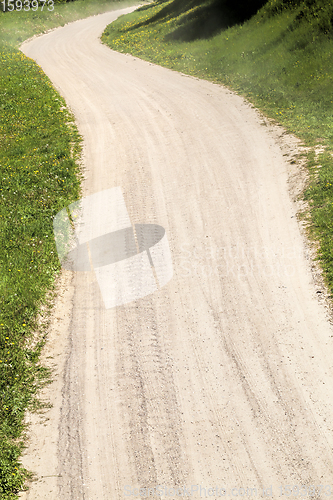 Image of part of a sandy road in the countryside