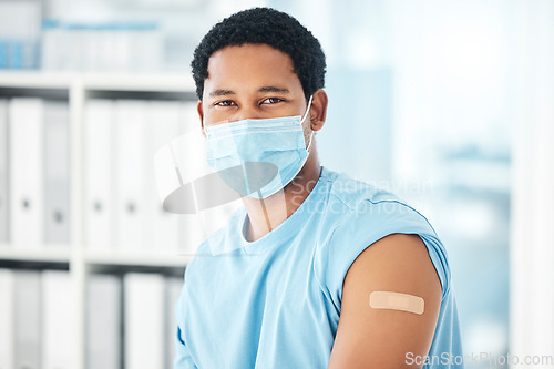 Image of Mask, vaccine and man with plaster in hospital for covid healthcare compliance. Young healthy African patient, clinic safety and corona prevention or medical immunity vaccination in health center