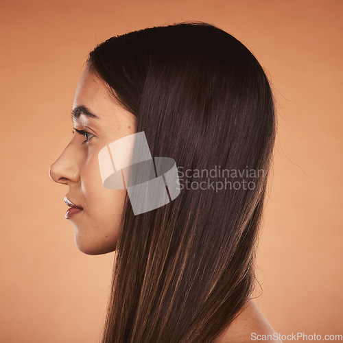 Image of Hair, beauty and woman face for healthy hairstyle and hair care on a brown studio background. Hair style, haircare and cosmetic treatment for shiny, healthy hair in a salon with a headshot profile